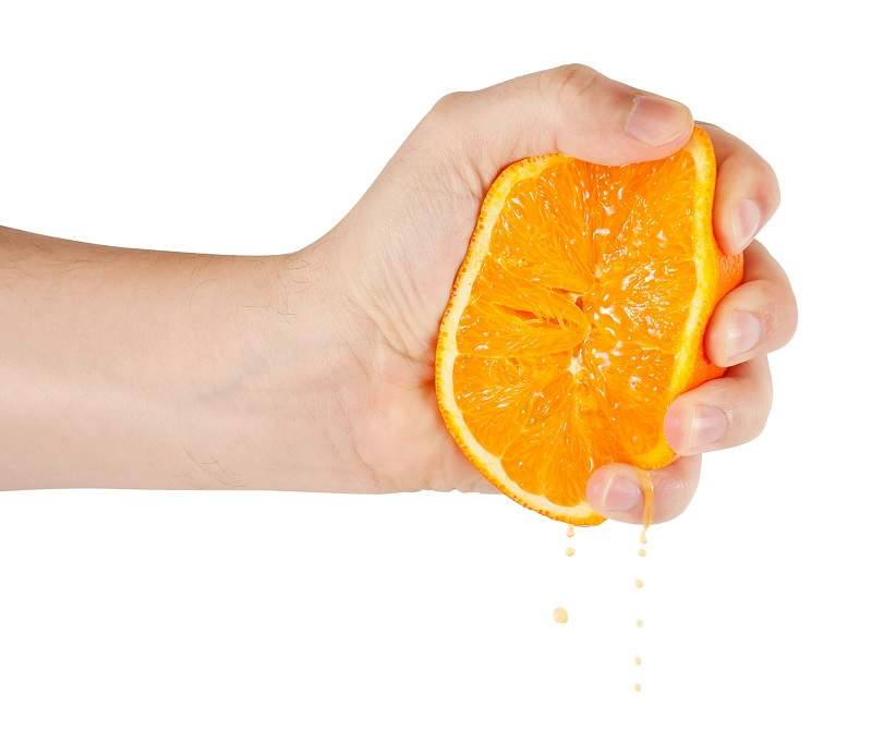 hand squeezing orange